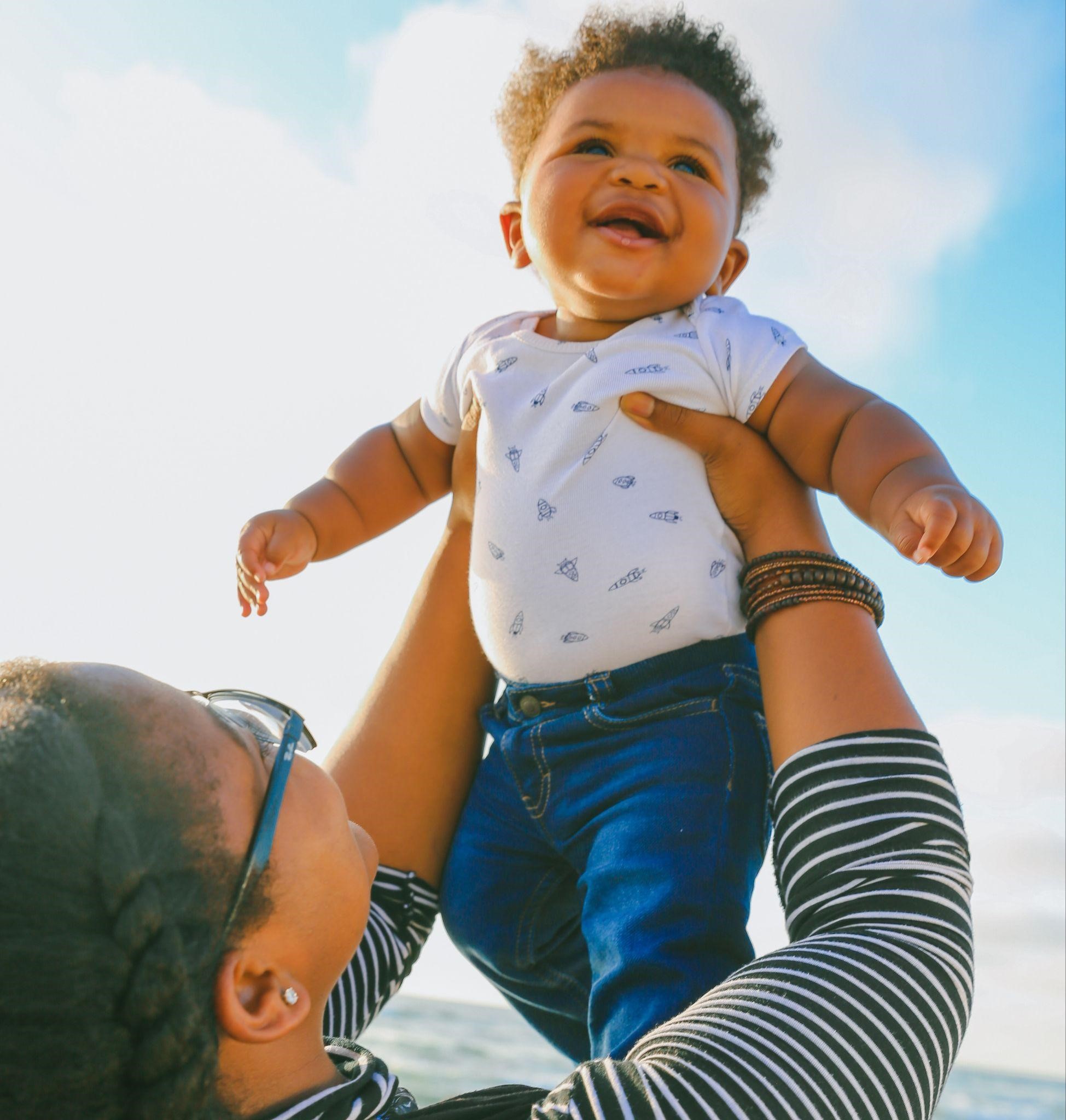 A mother holding her baby, sharing joint custody of the child with the father