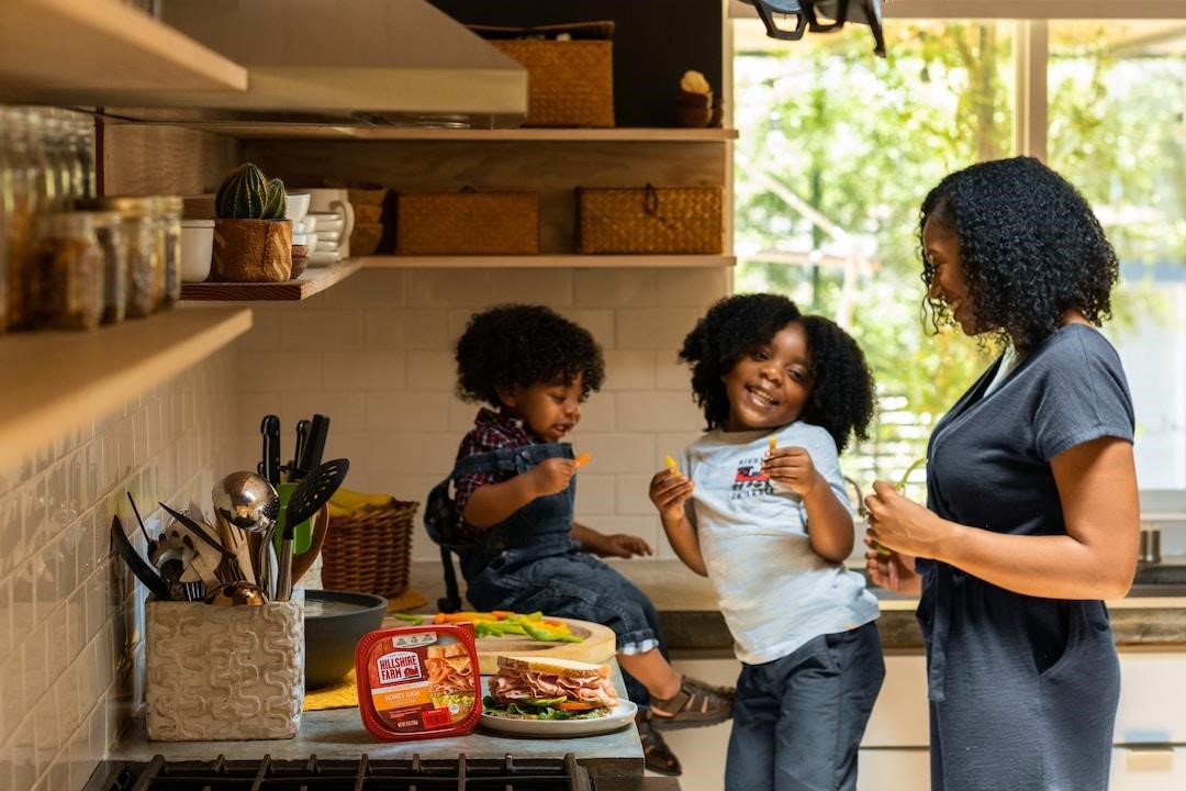Mother making lunch with her kids in the kitchen