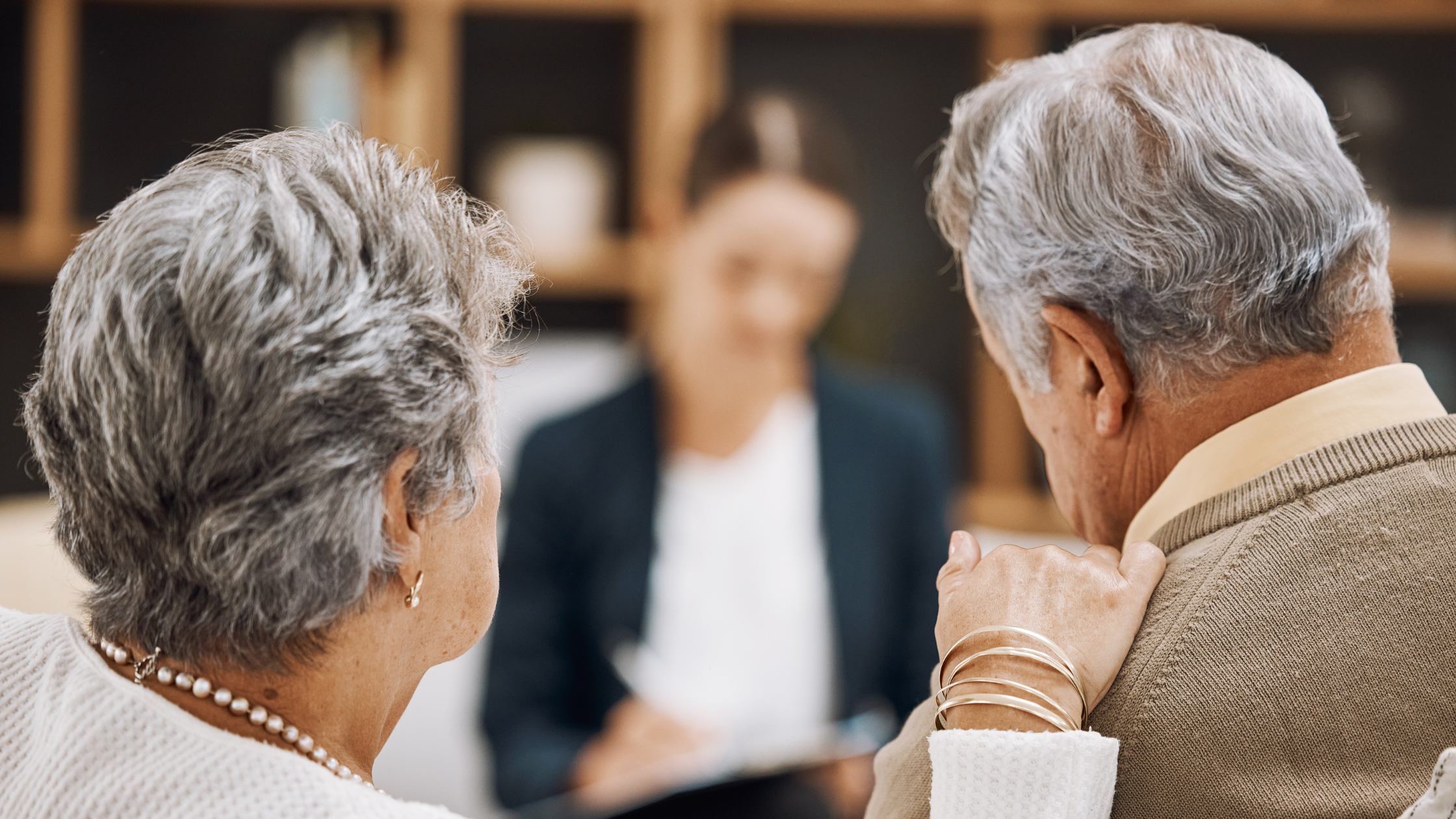 Two people discussing a trust with an attorney