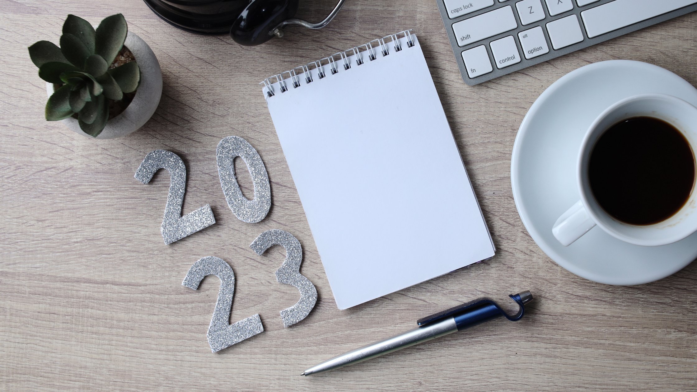 blank white notepad and 2023 numbers on table