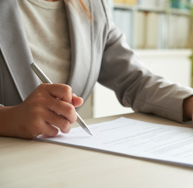 cropped-mid-section-unrecognizable-woman-signing-document 1