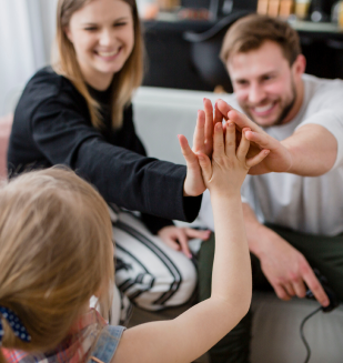 daughter-high-fiving-with-parents 1